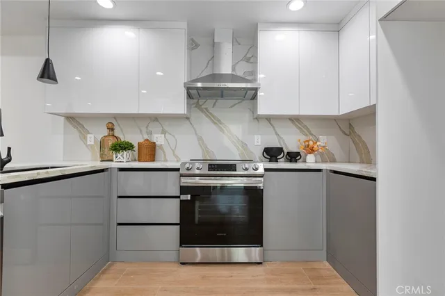 a stove top oven sitting inside of a kitchen