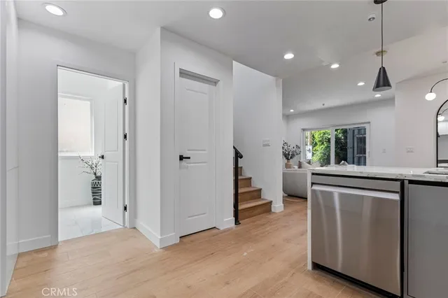 a view of kitchen with stainless steel appliances granite countertop a refrigerator and a sink