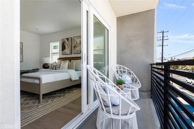 a bedroom with furniture and a wooden floor