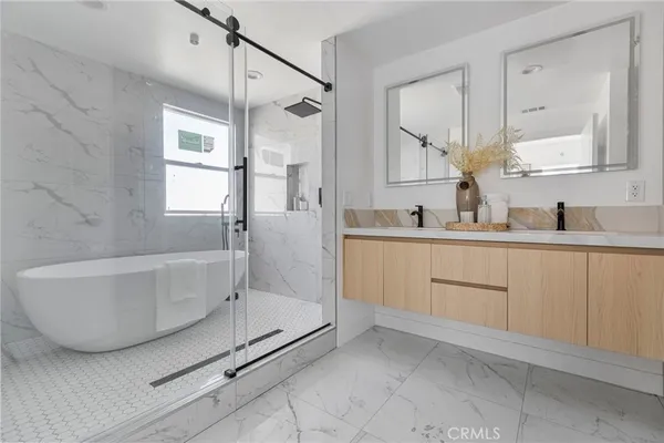 a bathroom with a double vanity sink a mirror and a shower