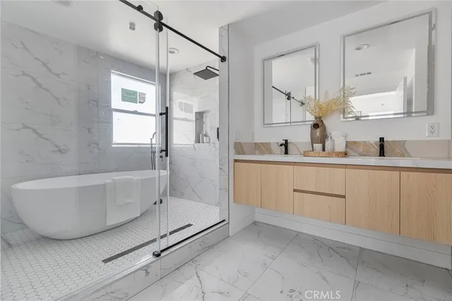 a bathroom with a double vanity sink a mirror and a shower