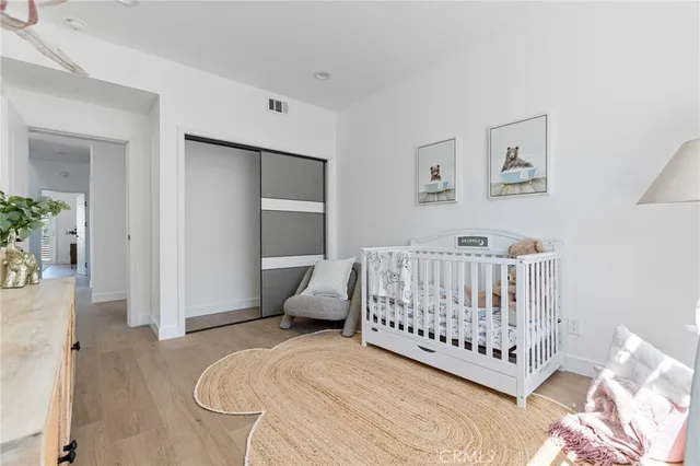 a bedroom with furniture and wooden floor