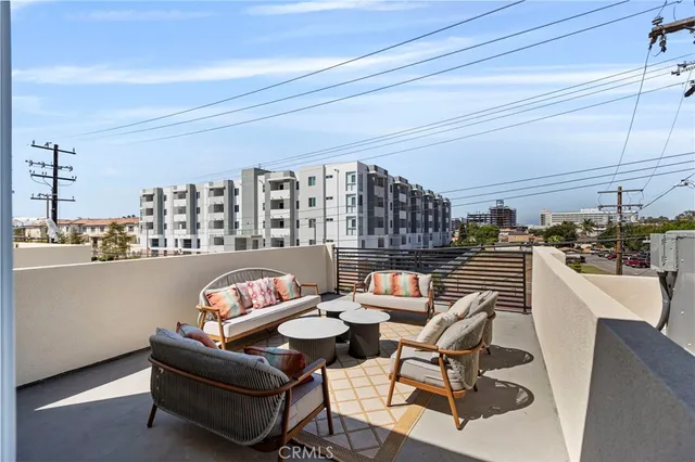 a living room with furniture and a kitchen view