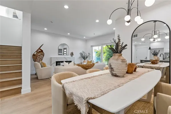a living room with fireplace furniture and a chandelier