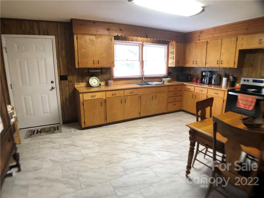 790 South Main Street Rutherfordton, NC 28139 - Photo 7 of 21 a kitchen with a stove a sink a counter space and a window