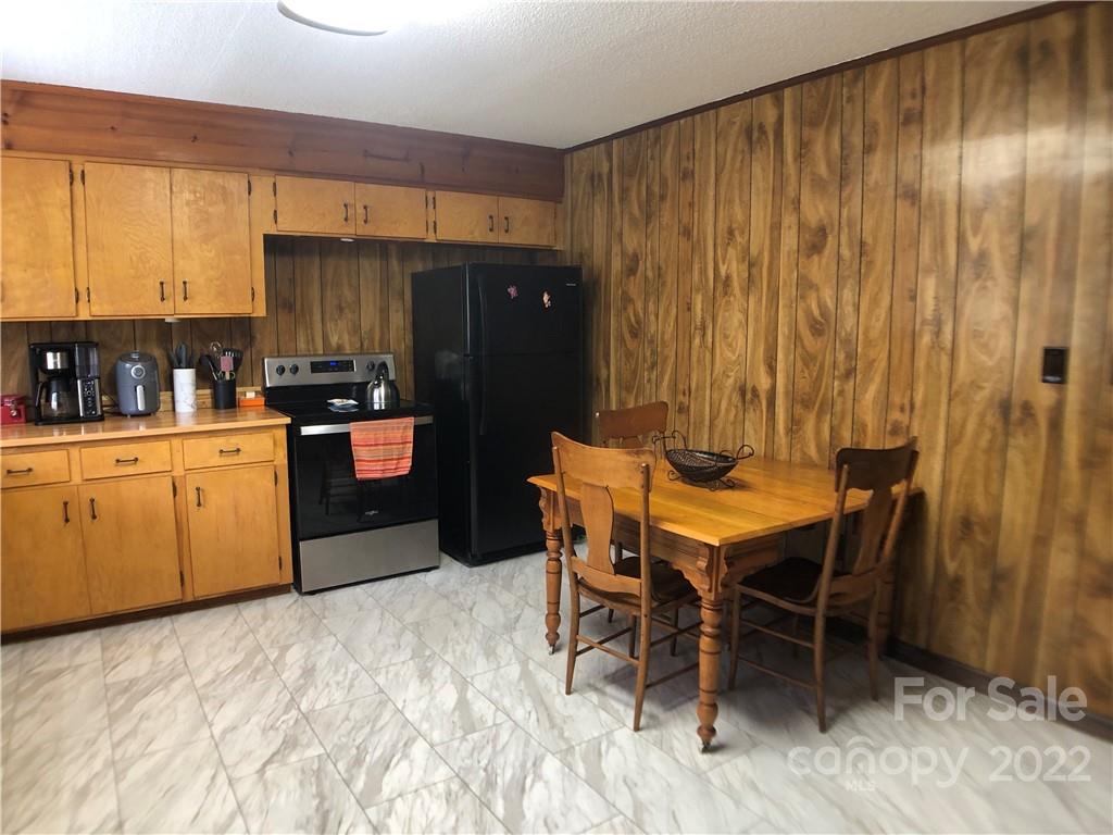 790 South Main Street Rutherfordton, NC 28139 - Photo 8 of 21 a kitchen with a table chairs refrigerator and cabinets