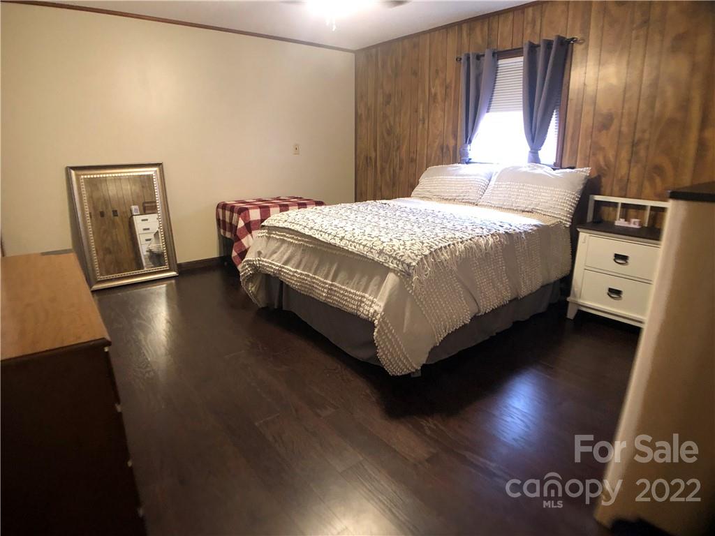 790 South Main Street Rutherfordton, NC 28139 - Photo 10 of 21 a bedroom with a bed and wooden floor