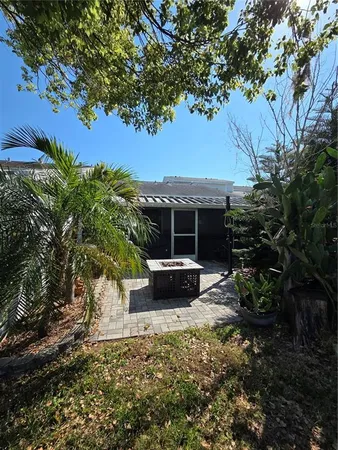 a view of a house with backyard sitting area and garden