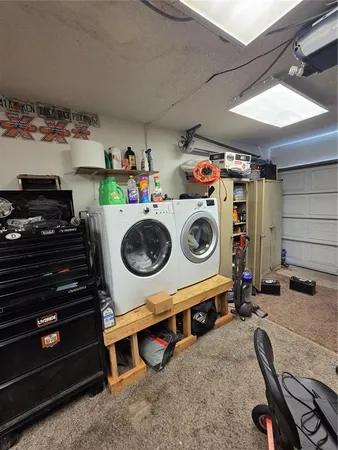 a view of a white house with a swimming pool lawn chairs and a fire pit
