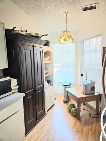 a view of a room with furniture and wooden floor