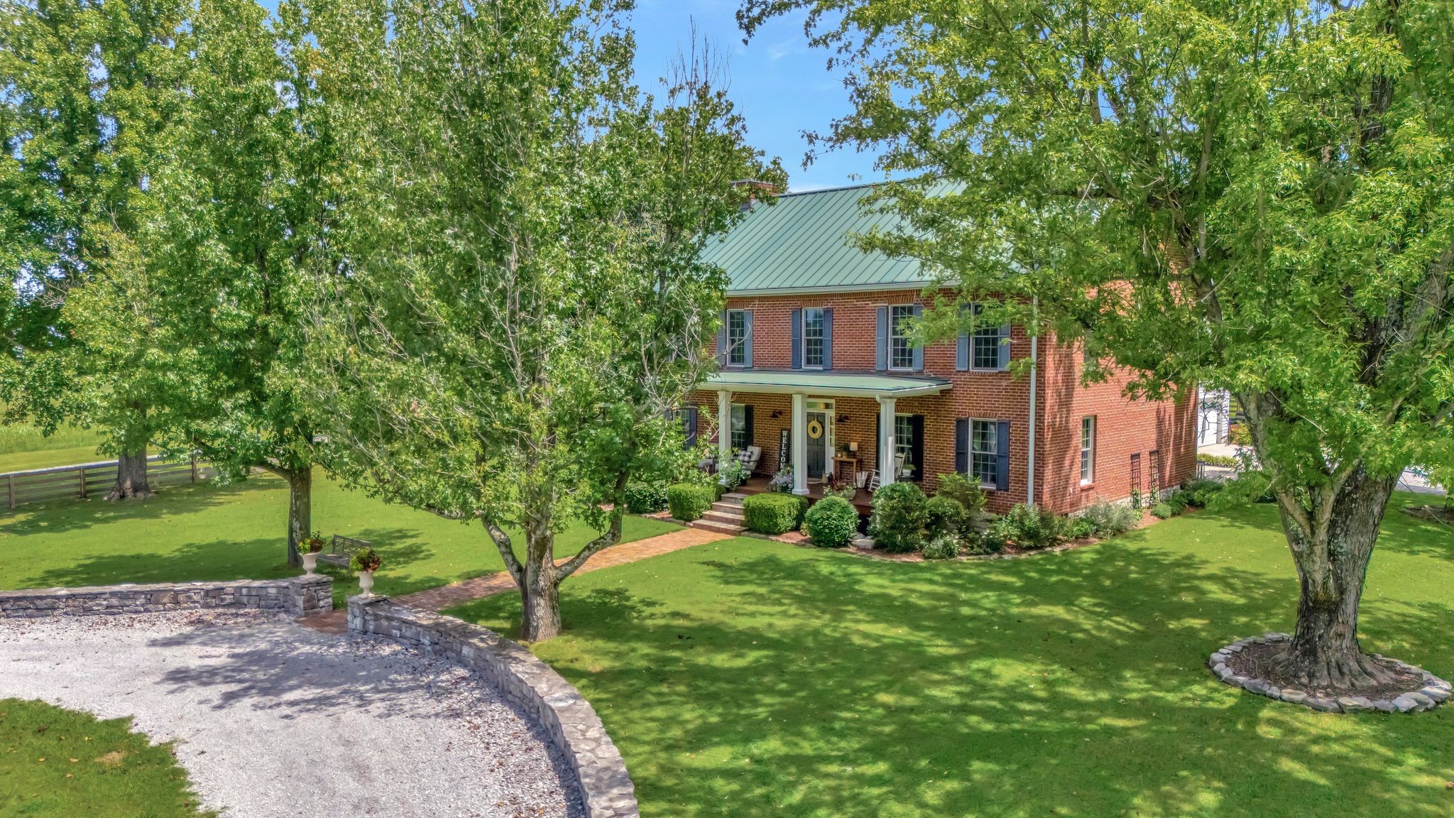 1605 Big Springs Road Lebanon, TN 37087 - Photo 1 of 65 a view of a brick house with a yard and plants