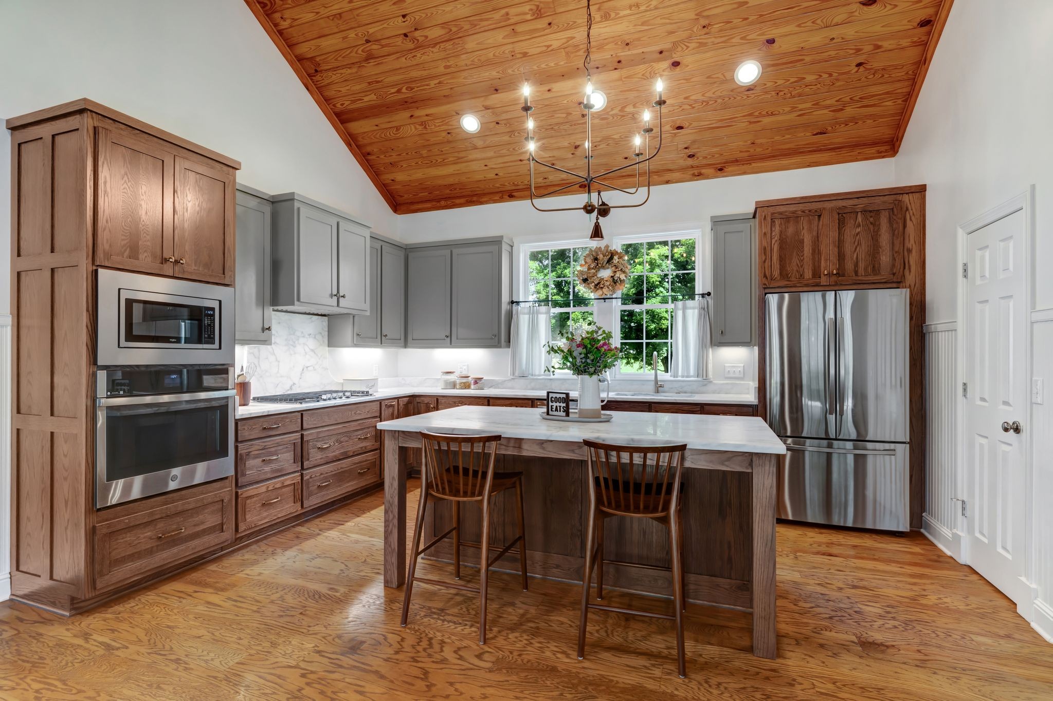 1605 Big Springs Road Lebanon, TN 37087 - Photo 18 of 65 a kitchen with stainless steel appliances granite countertop a stove a refrigerator a sink dishwasher a dining table and chairs with wooden floor