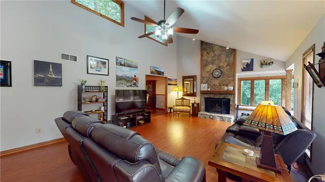 a living room with furniture a fireplace and a flat screen tv