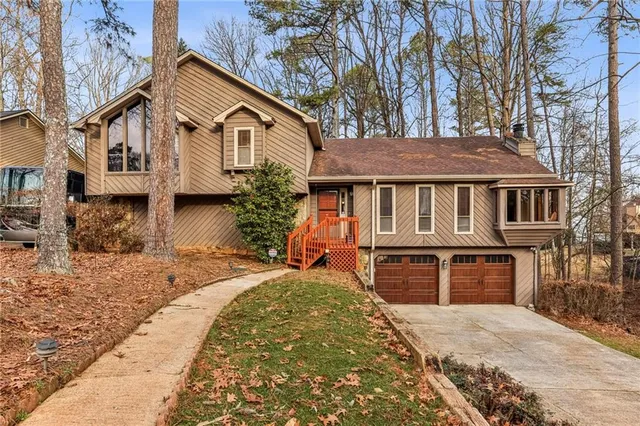a front view of a house with a yard covered with snow in front of house