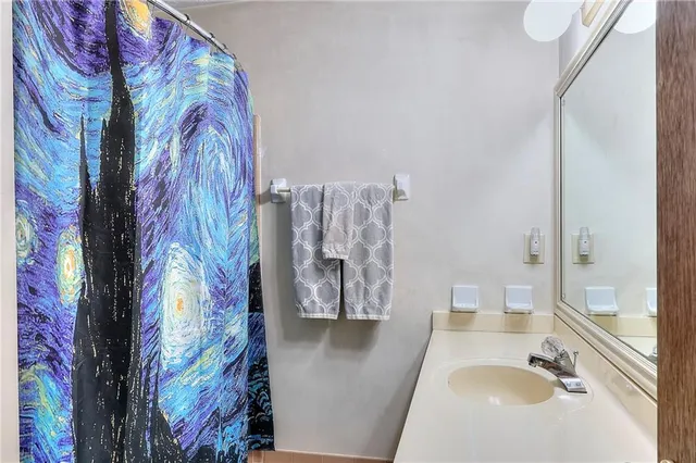 a bedroom with a bed and a desk