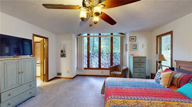 a bedroom with a bed and a couch