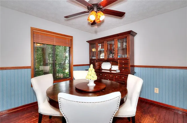 a dining room with furniture a chandelier and wooden floor