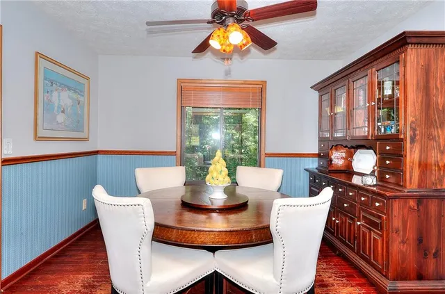 a dining room with furniture and wooden floor