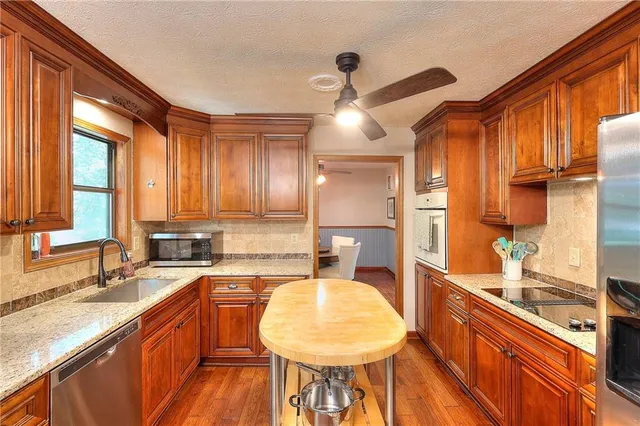 a large kitchen with a large window and stainless steel appliances