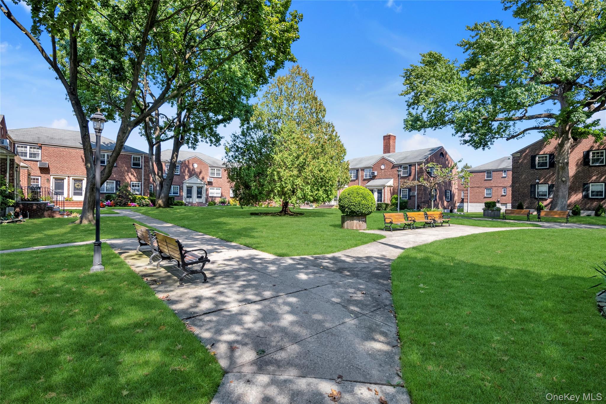 211-11 73rd Avenue, Unit B Queens, NY 11364 - Photo 11 of 11 a view of a park with bench and trees