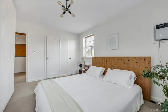 a bedroom with a bed and a potted plant