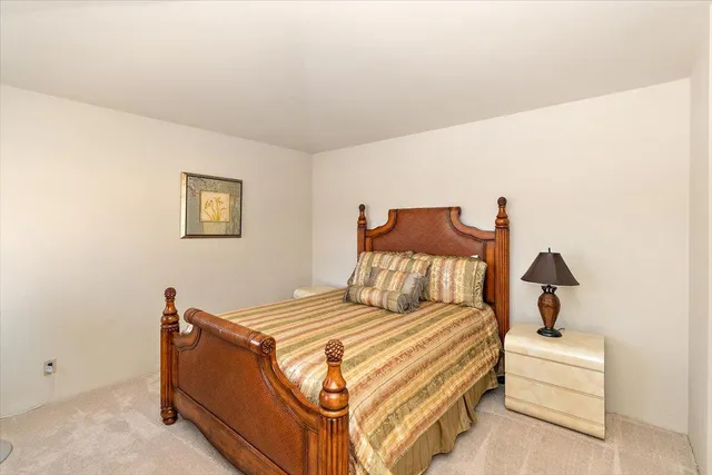 a bedroom with a bed and a lamp with window