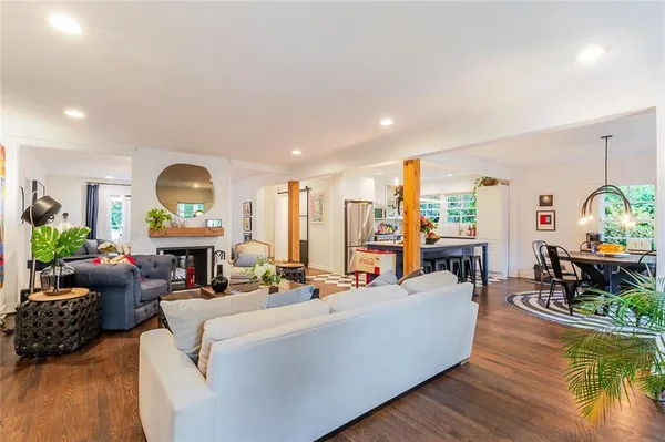 a living room with furniture fireplace and wooden floor