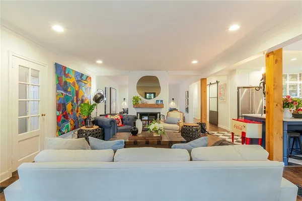 a living room with furniture a rug and white walls