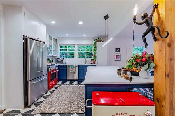 a living room with furniture pool table and kitchen view
