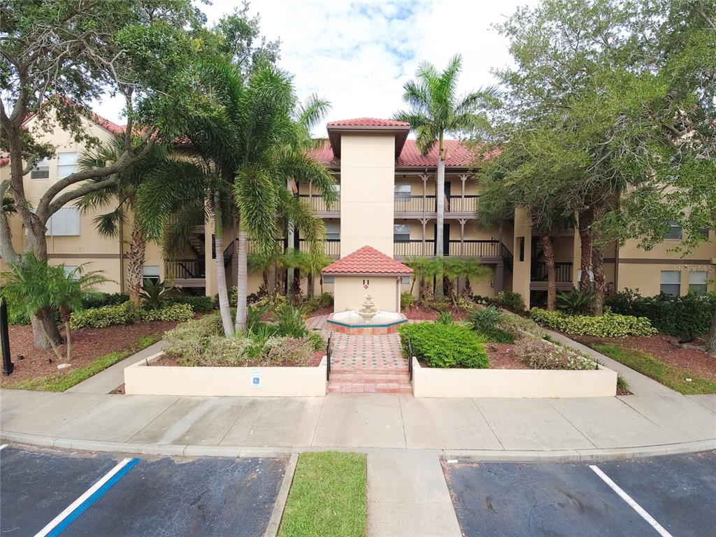 2400 Feather Sound Drive, Unit 1128 Clearwater, FL 33762 - Photo 1 of 43 a front view of a house with fountain and fountain
