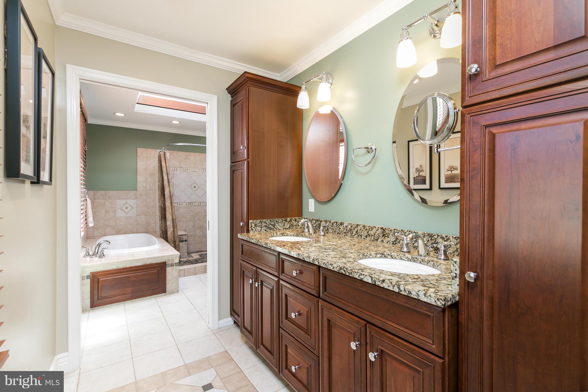 10807 Cross School Road Reston, VA 20191 - Photo 15 of 30 a spacious bathroom with a sink double vanity and a mirror