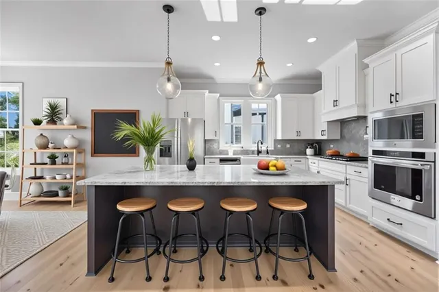 a view of an empty room with wooden floor fireplace and a window