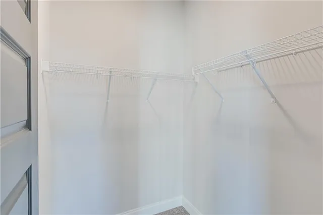 an empty room with closet and windows