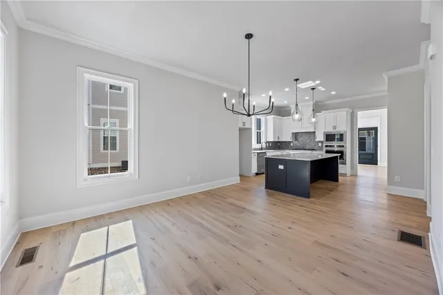 a view of a dining room with furniture a livingroom and wooden floor
