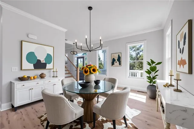 a living room with furniture a chandelier and a flat screen tv