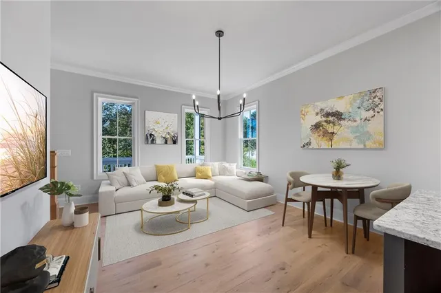 a dining hall with stainless steel appliances granite countertop a kitchen island a refrigerator wooden floor and a sink