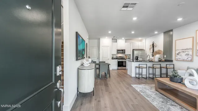 a view of a kitchen with furniture and wooden floor