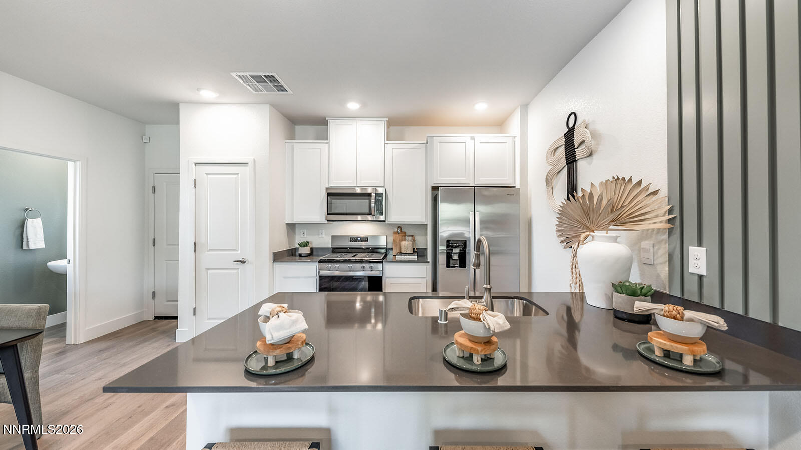 1596 Grazer Way Reno, NV 89523 - Photo 7 of 25 a kitchen with stainless steel appliances kitchen island granite countertop a stove a refrigerator and cabinets