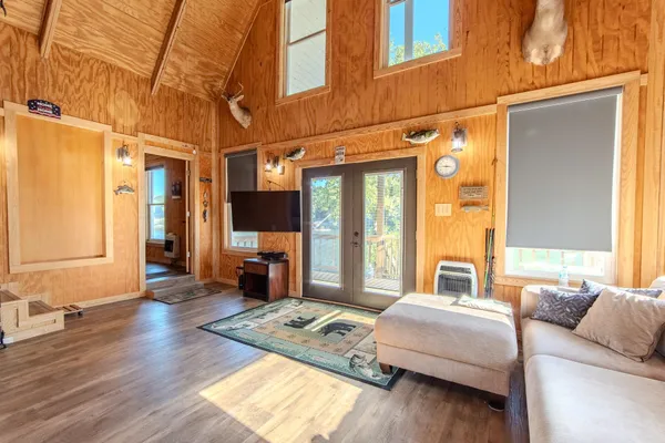 a bedroom with a large bed and wooden floor