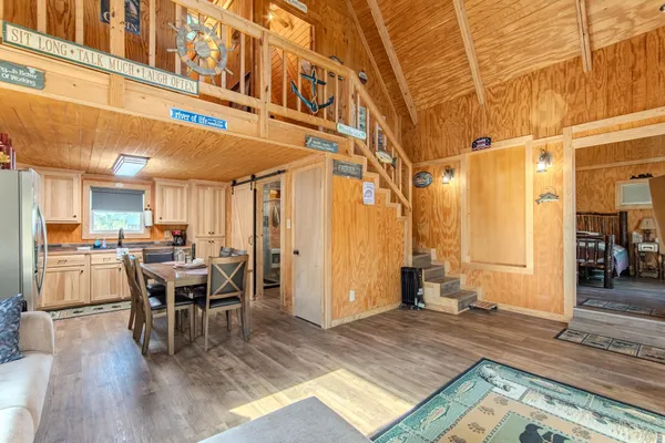 a view of a dining hall with furniture and wooden floor