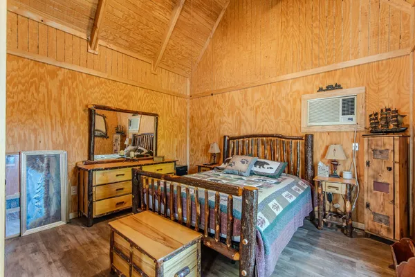 a bedroom with a bed next to a window