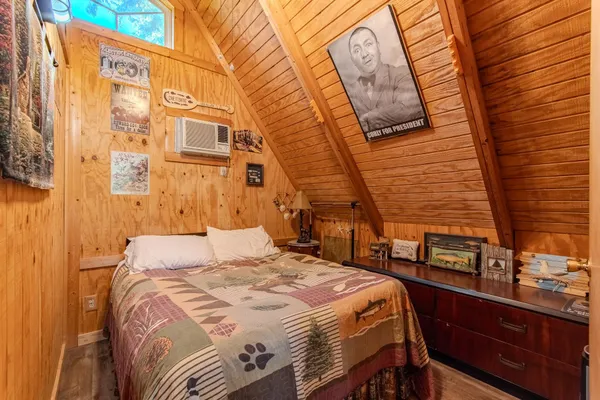 a bedroom with a bed and a night stand