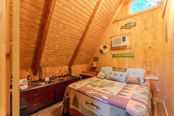 a bed room with a bed and a chair