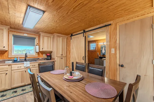 a kitchen with granite countertop lots of table and chairs