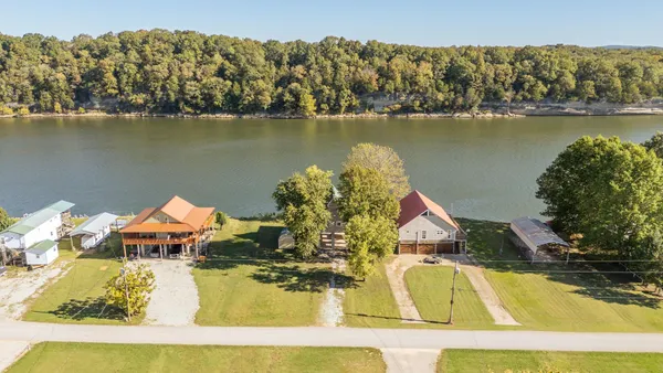 an aerial view of a house with a lake view