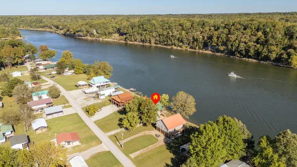an aerial view of a house with a lake view