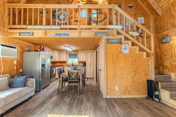 a dining room with furniture and wooden floor
