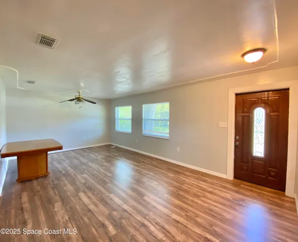 wooden floor in an empty room with a window
