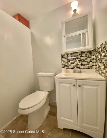 a white toilet sitting next to a bathroom sink