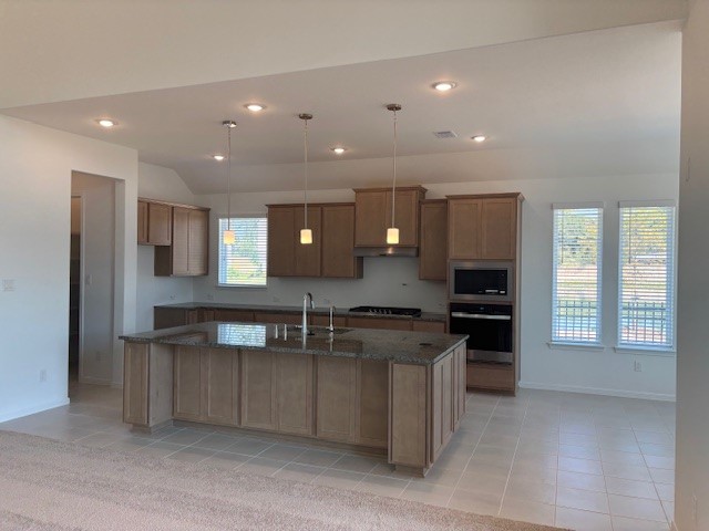 32364 Mossy Pine Way Spring Spring, TX 77386 - Photo 2 of 10 a kitchen with stainless steel appliances granite countertop a stove and a sink